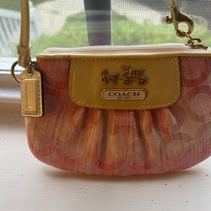 Coach wristlet Sm pouch/carry strap/original light pink has small mark on front